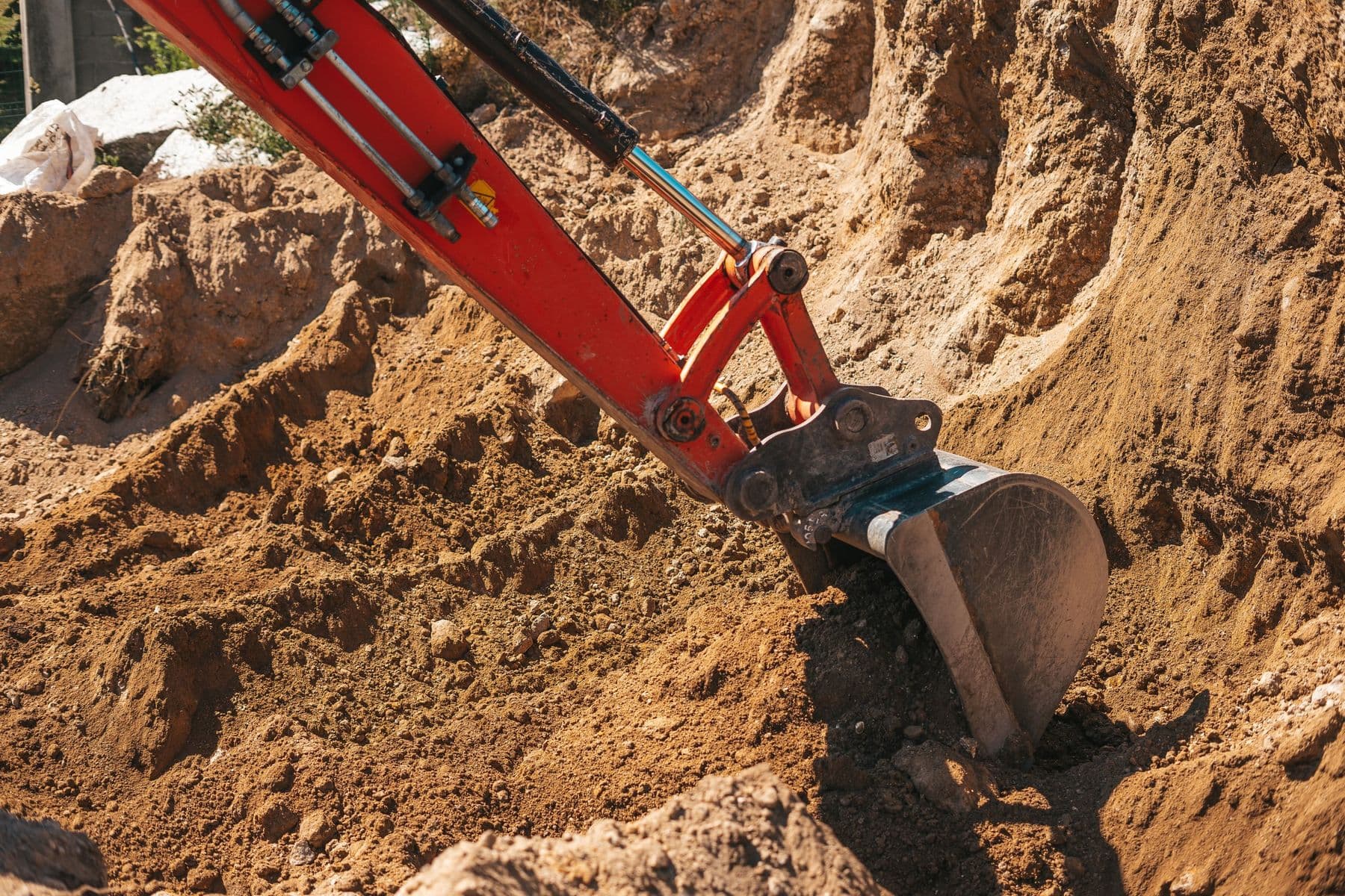 Excavation work in progress with utility marking flags